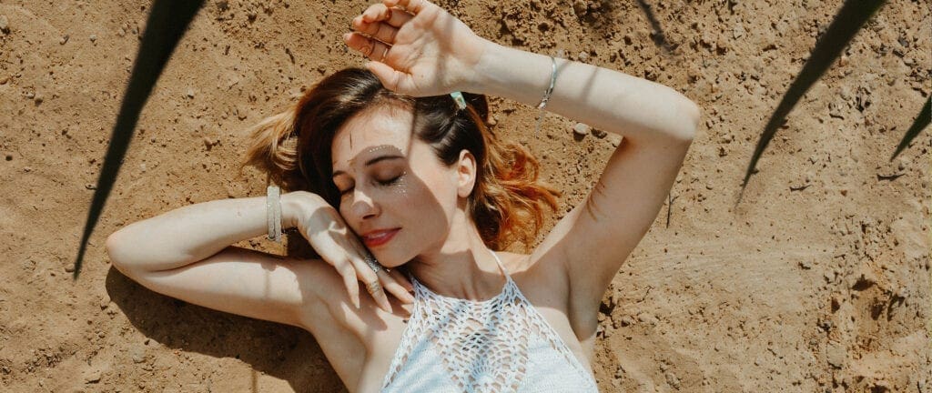 Girl enjoying the sunshine - protect the health of your skin with suncream