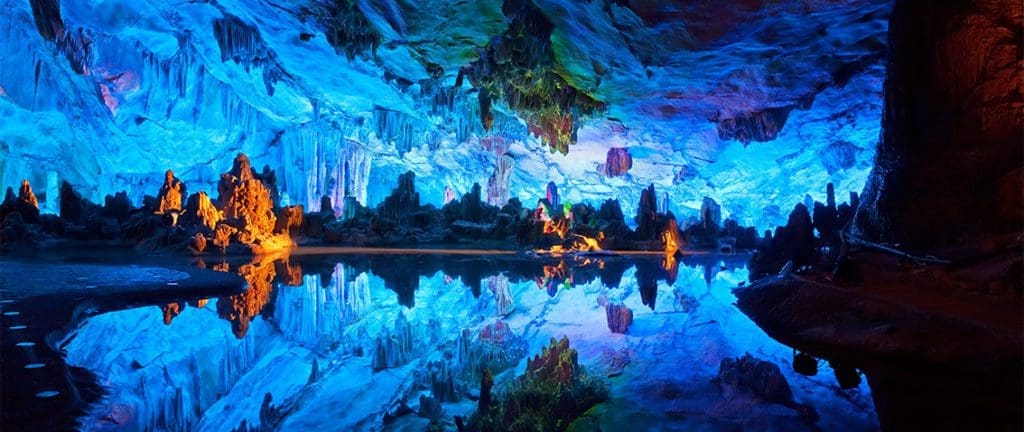 Reed Flute Cave in the reflection of a body of water