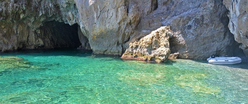 A mesmerizing image of the Emerald Cave, featuring its enchanting emerald-hued waters illuminated by natural light, creating a captivating and magical ambiance. Perfect travel destination along the Amalfi Coast.