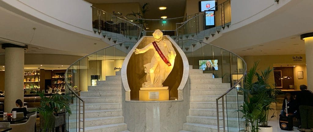 Main lobby of Don Giovanni Hotel with Mozart statue in the middle